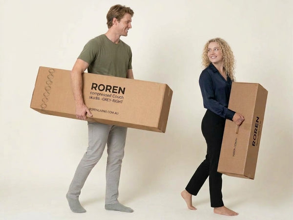 Two people holding ROREN compressed sofa boxes